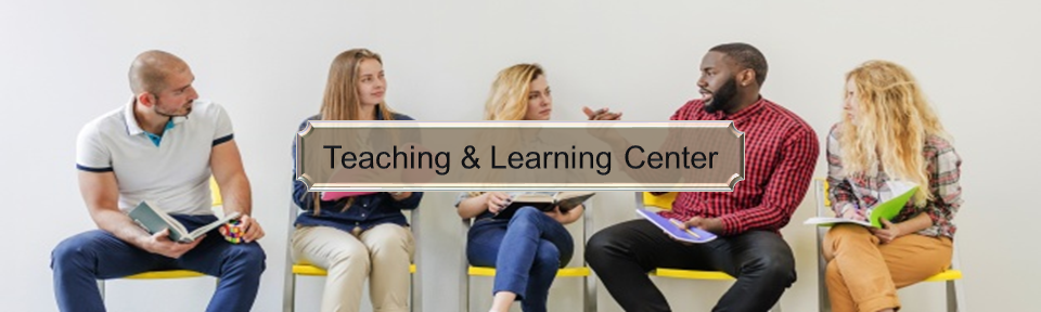 Teachers sitting in chairs in a line against a wall, talking to one another.